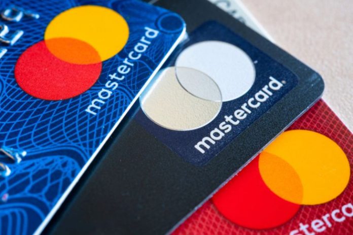 In this photo illustration there are three Mastercard Credit