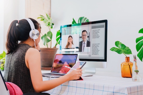 Asian business woman work from home with laptop, tablet and computer on table with meeting online and video conferencing.Concept of social distancing to stop the spread disease of Corona virus.